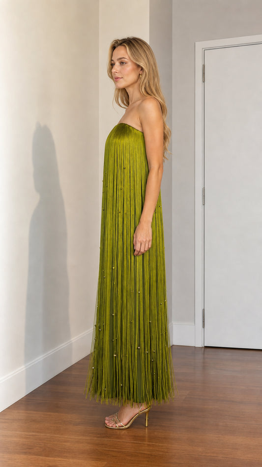 Side profile of woman wearing olive green fringe maxi dress with heels