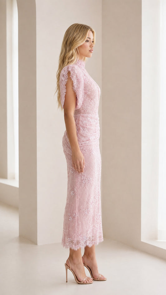 Side profile view of model in pink lace dress