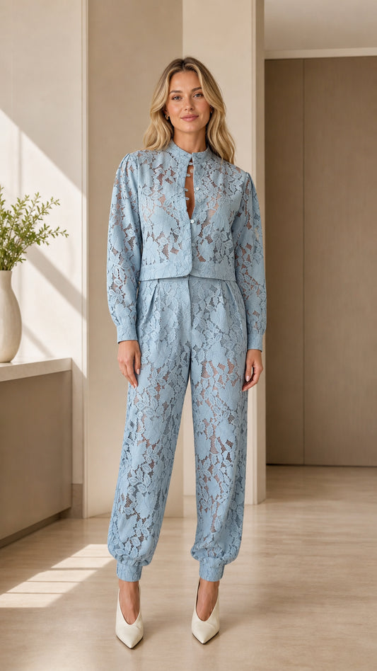 Front view of woman wearing light blue floral lace top and jogger pants set
