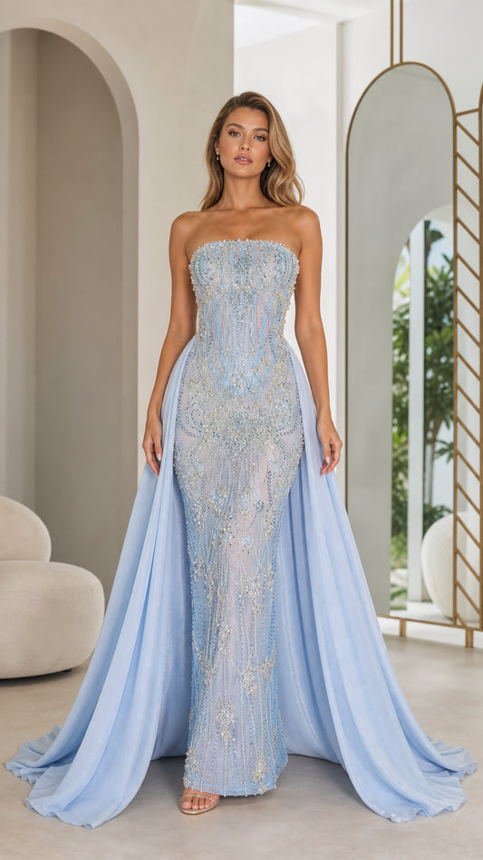 Front view of light blue strapless beaded mermaid evening gown with overskirt