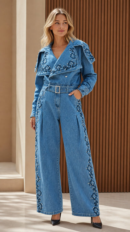 Model wearing blue embroidered denim jumpsuit with statement collar, front view