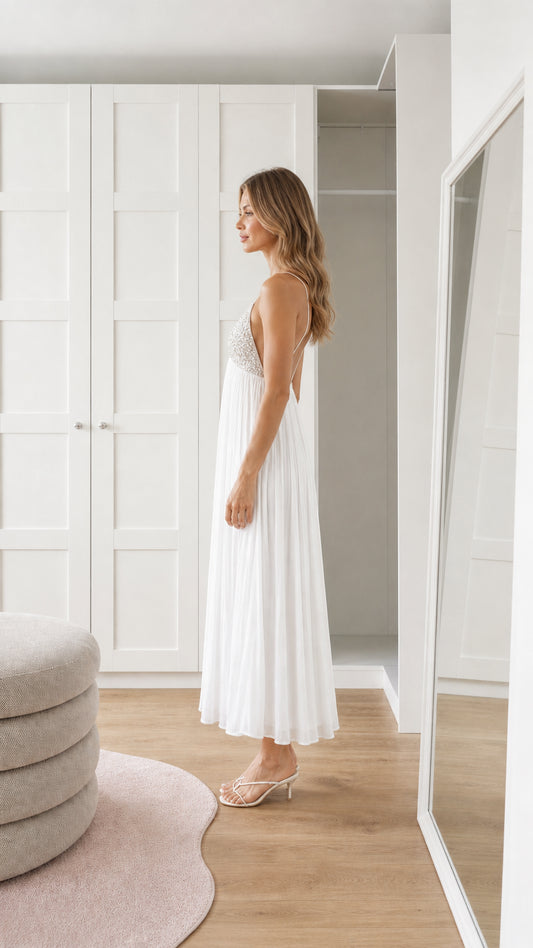 Side view of white sequin pleated maxi dress