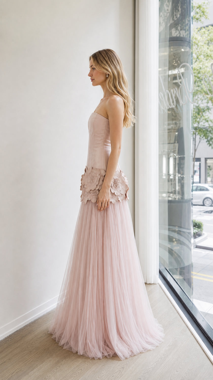 Side profile view of blush pink strapless evening gown