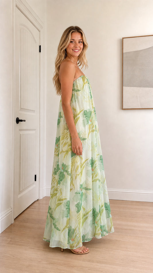 Model wearing sage green floral strapless maxi dress side view