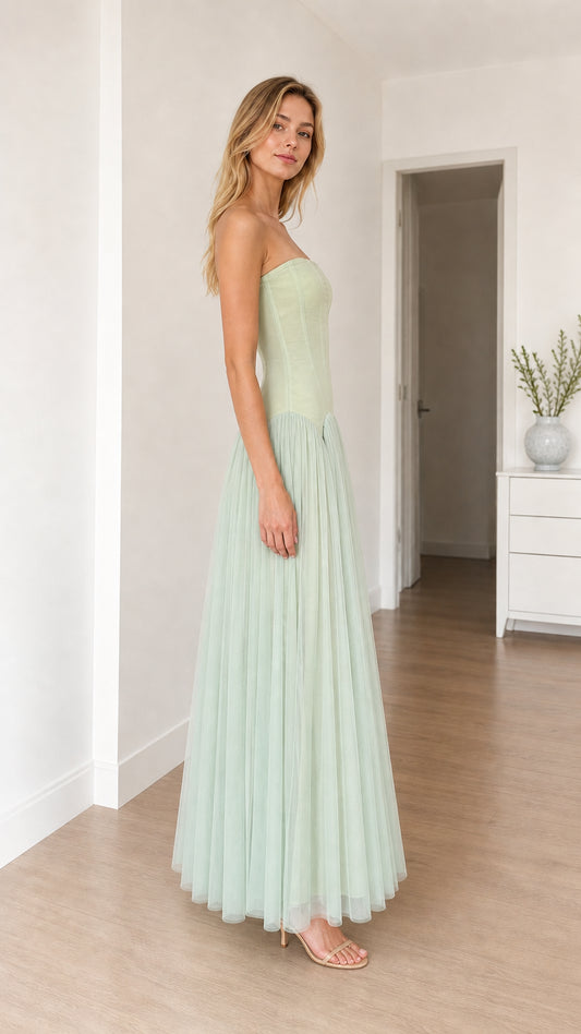 Model in sage green dress, side profile