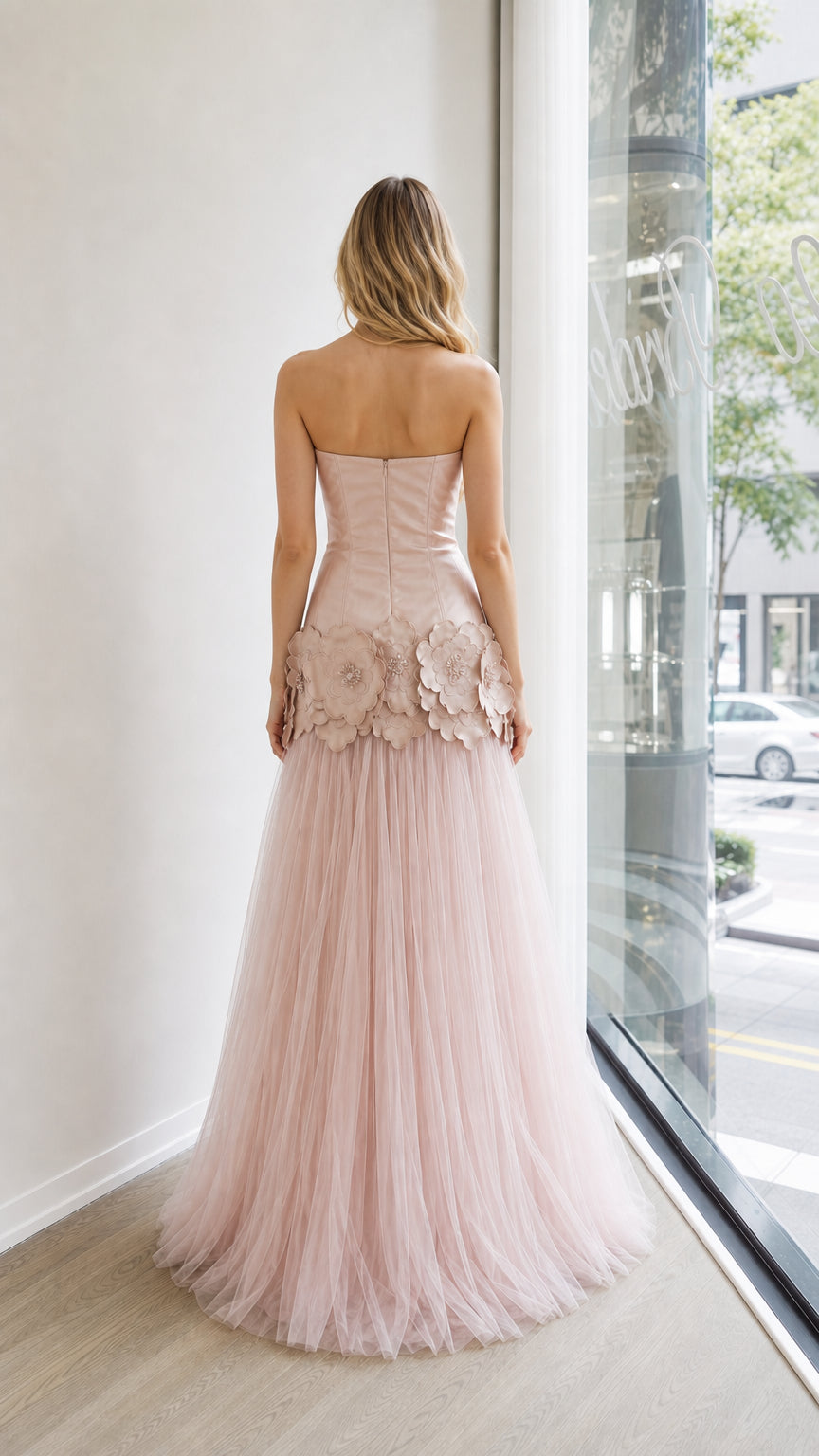 Back view of blush pink strapless tulle evening gown