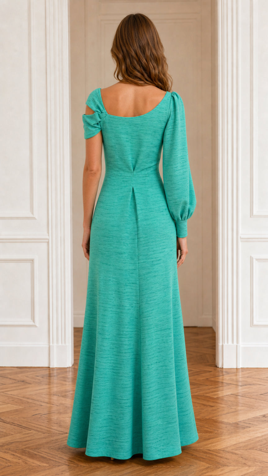 Back view of model showcasing back seam detailing on teal maxi dress