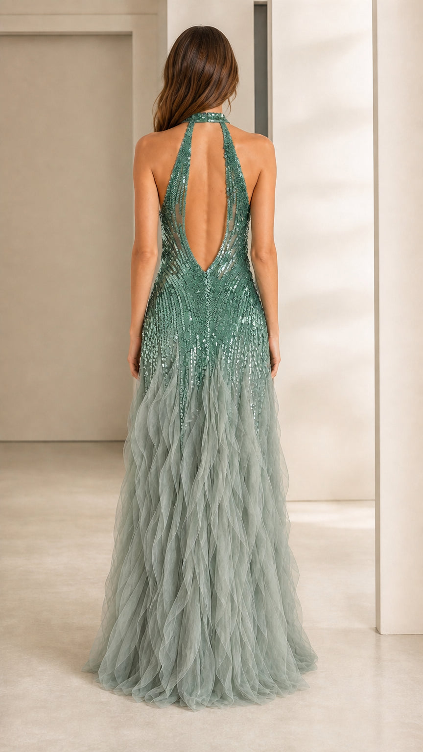 Back view showing open back and tulle train of green gown