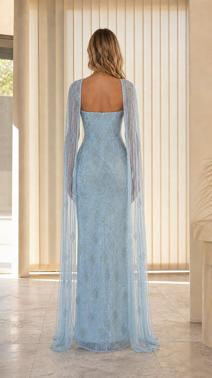 Light blue evening gown back view with flowing cape