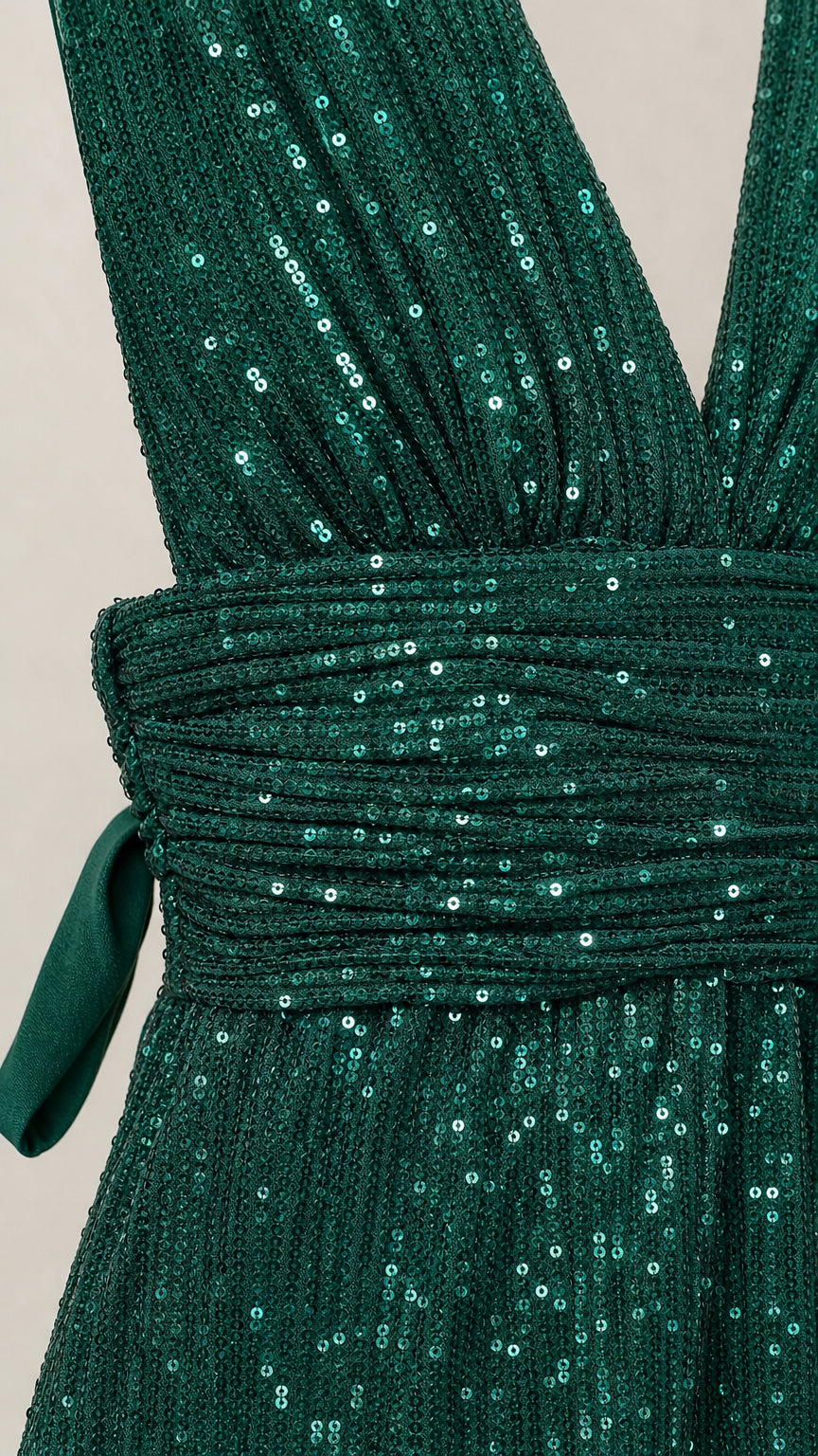 Close-up detail of the sequin texture and pleated waist sash