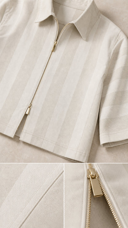Close-up detail of zipper, collar, and striped fabric texture