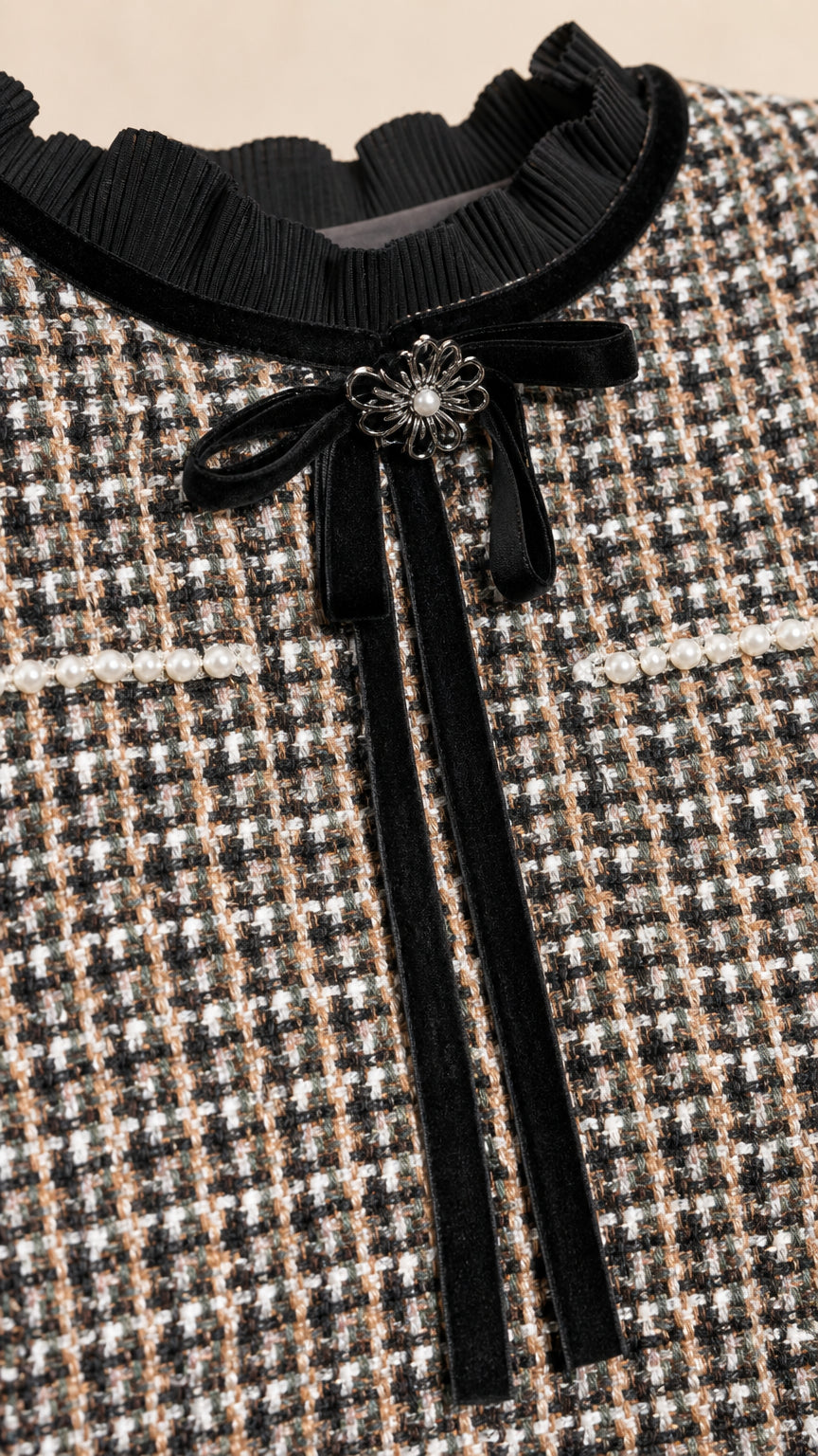 Close-up of velvet bow collar and tweed texture