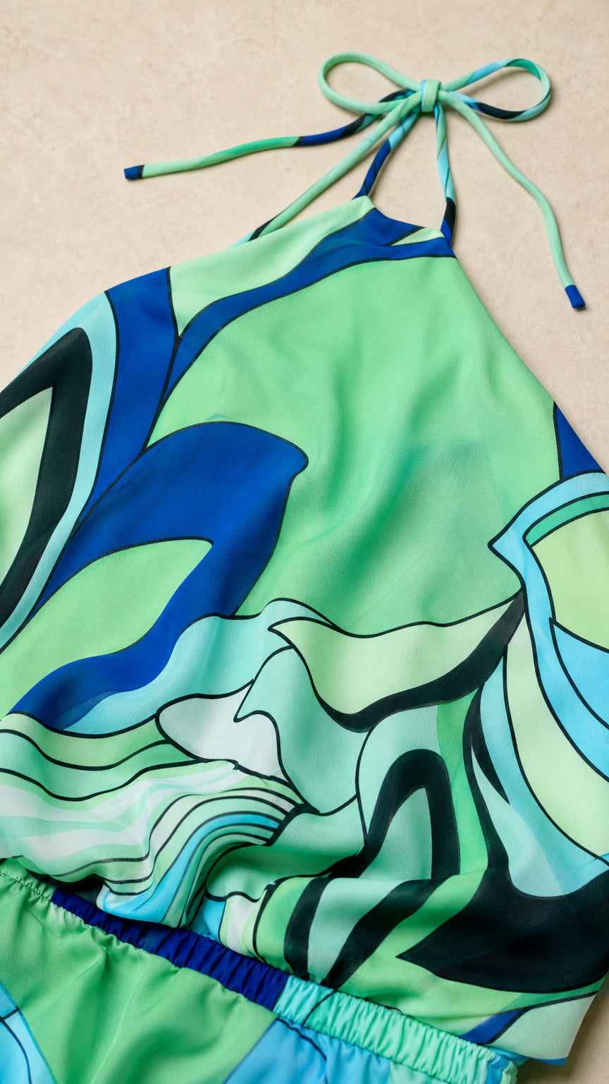 Close up of green abstract print halter top tie detail