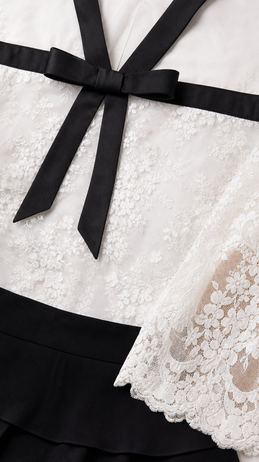 Close-up detail of the lace bodice, neckline, and contrast bow