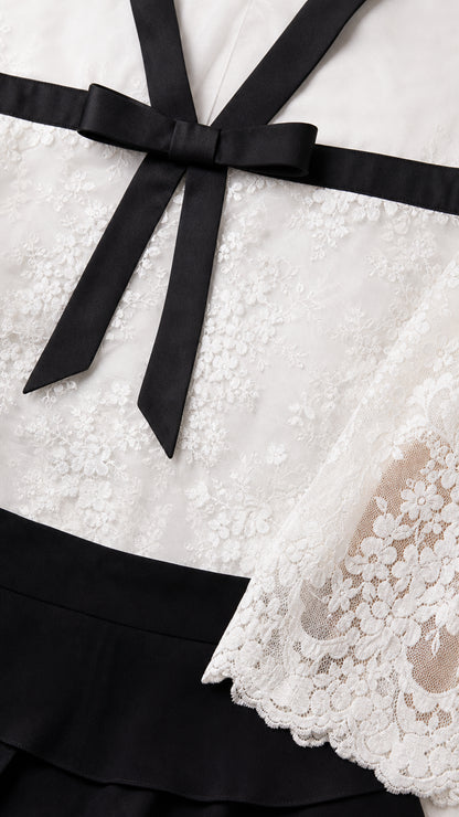 Close-up detail of the lace bodice, neckline, and contrast bow
