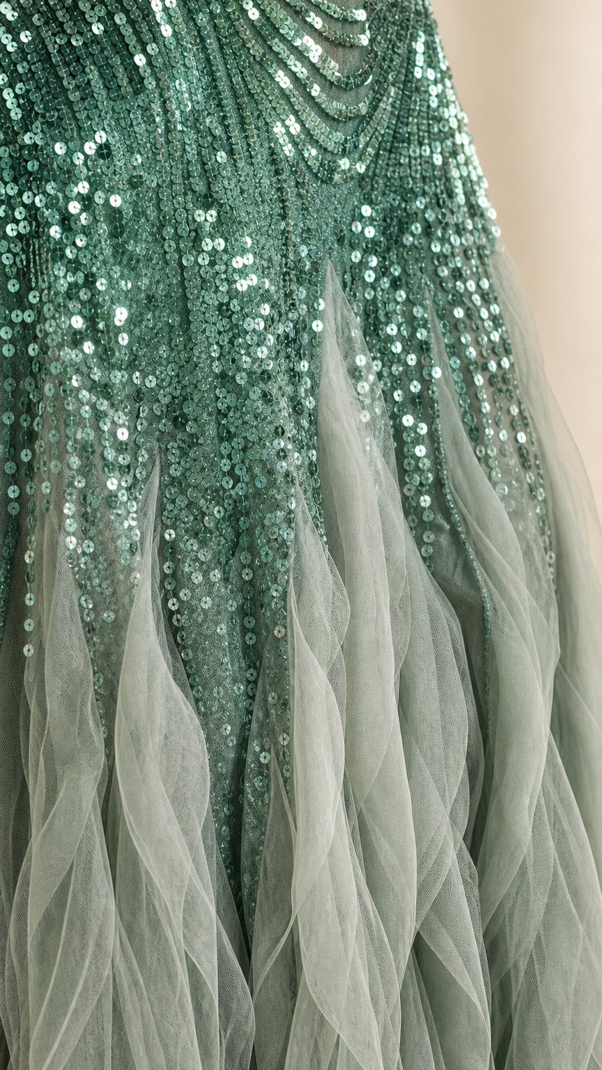 Close-up detail of green sequin embroidery and layered tulle
