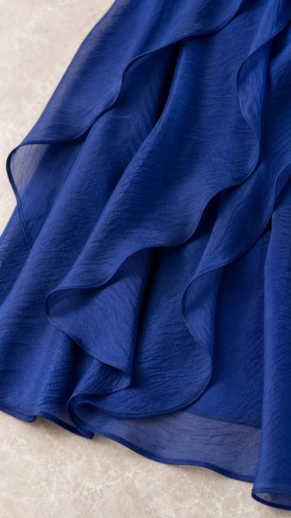 Close-up detail of textured chiffon fabric and ruffle trim
