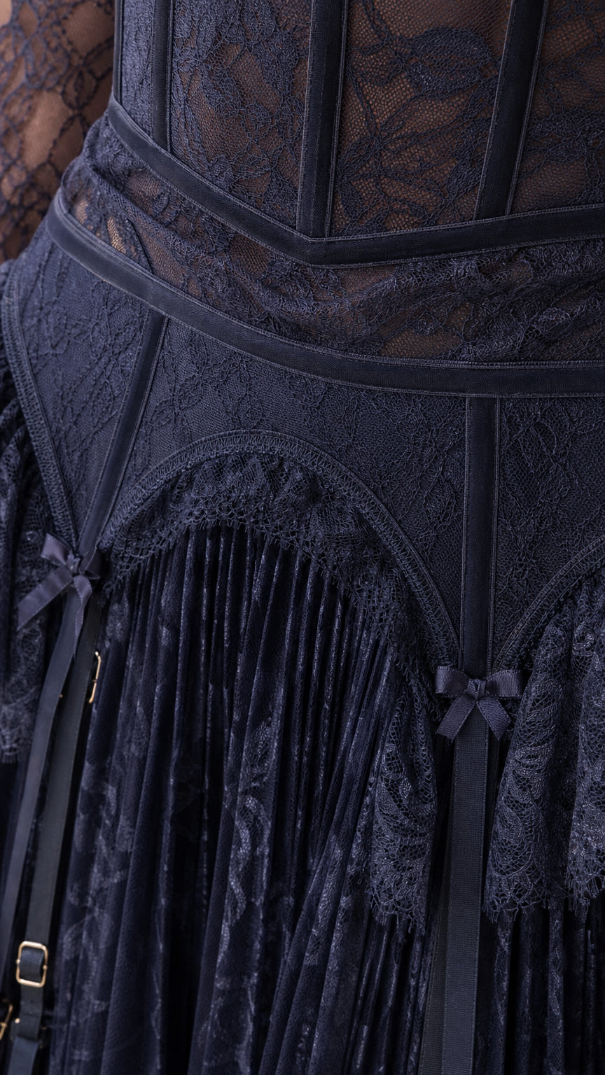 Close-up of structured corset bodice and pleated skirt on Navy lace dress