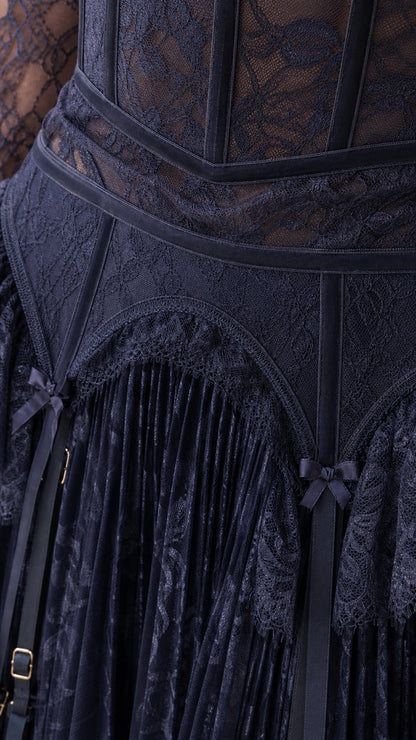 Close-up of structured corset bodice and pleated skirt on Navy lace dress
