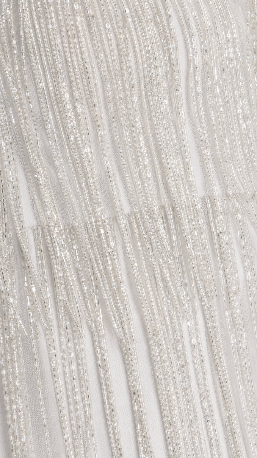 Close-up texture view of white beaded fringe fabric