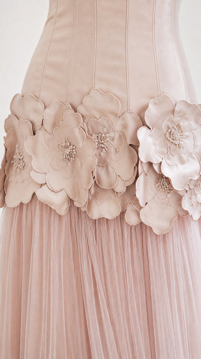 Close-up detail of 3D fabric flowers and beading on the dress waist