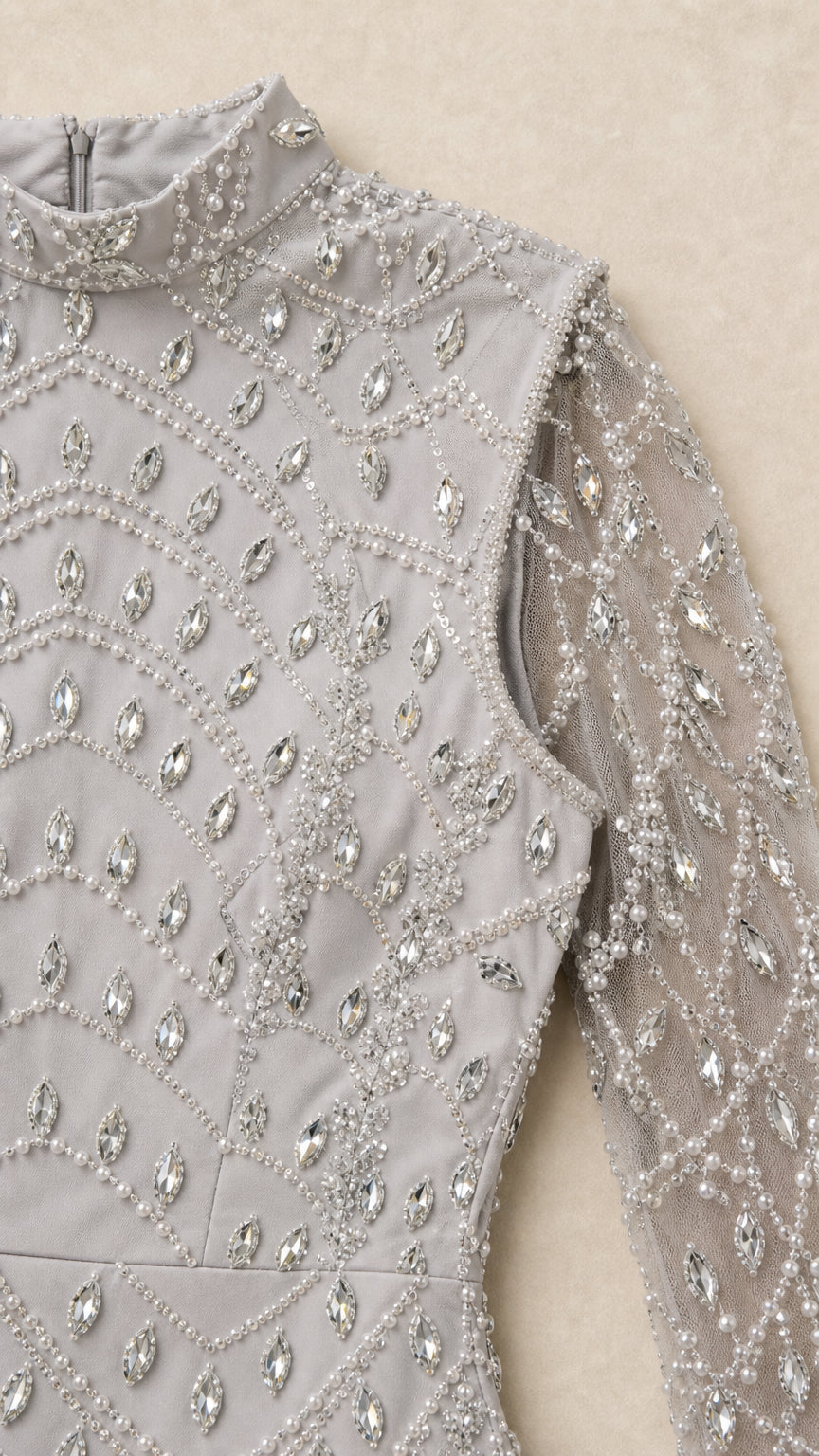 Close-up detail of rhinestone and bead pattern on silver high neck bodice
