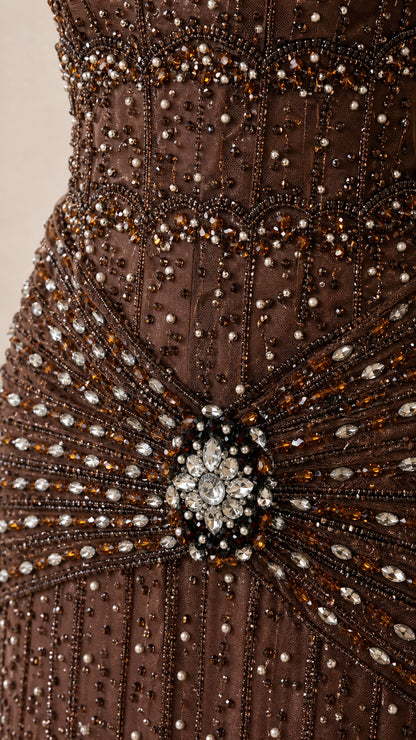 Close-up detail of the crystal waist brooch and beadwork