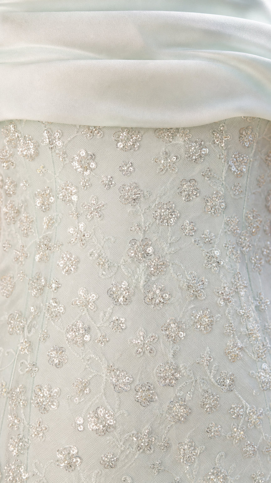 Close-up of sequin lace texture and satin foldover collar