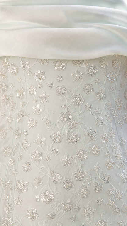 Close-up of sequin lace texture and satin foldover collar