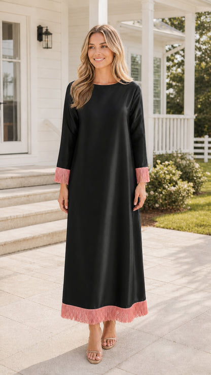 Front view of black maxi dress with pink fringe trim