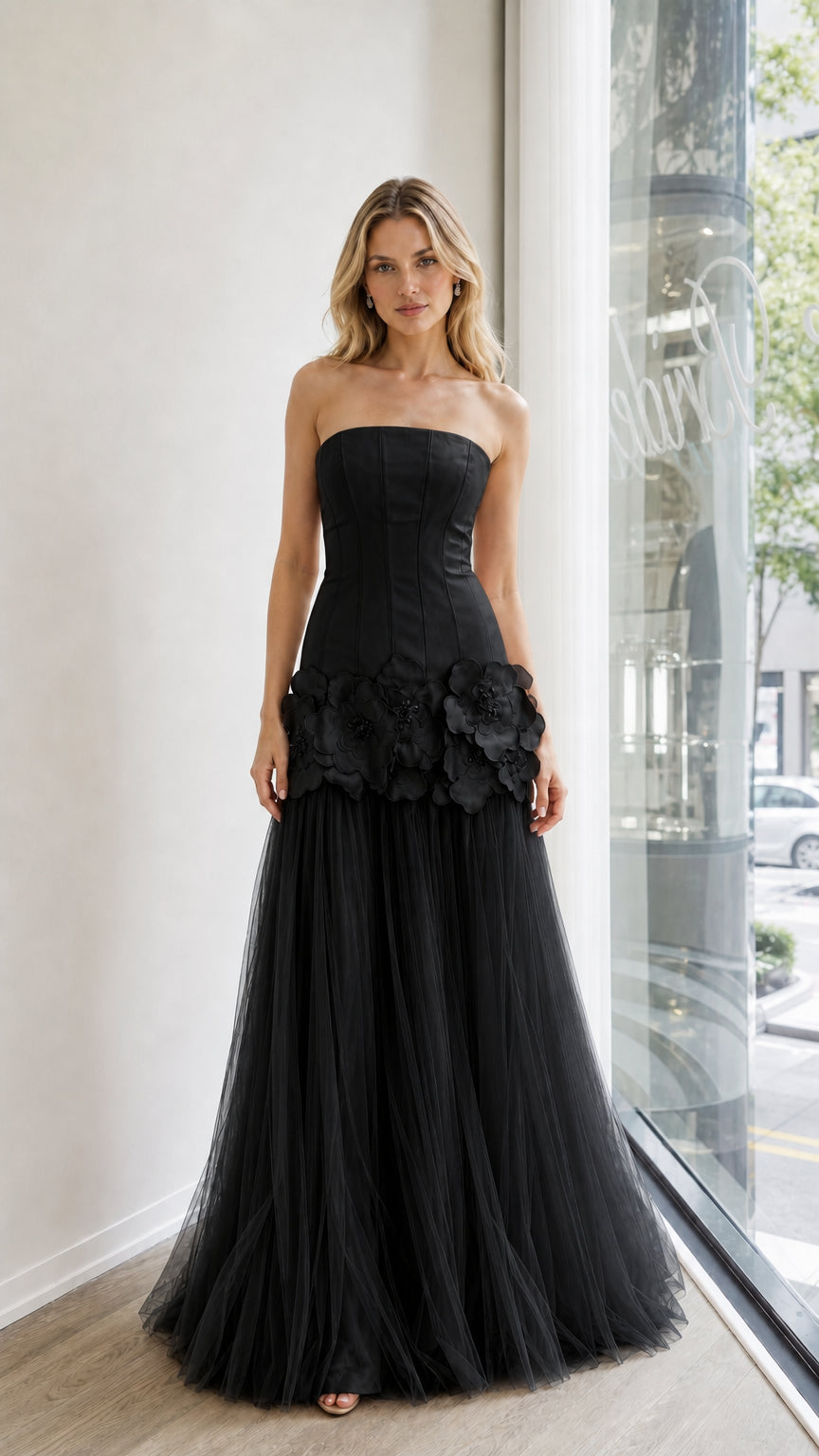 Front view of black strapless evening dress with floral appliques