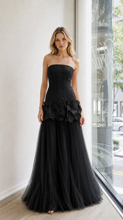 Front view of black strapless evening dress with floral appliques