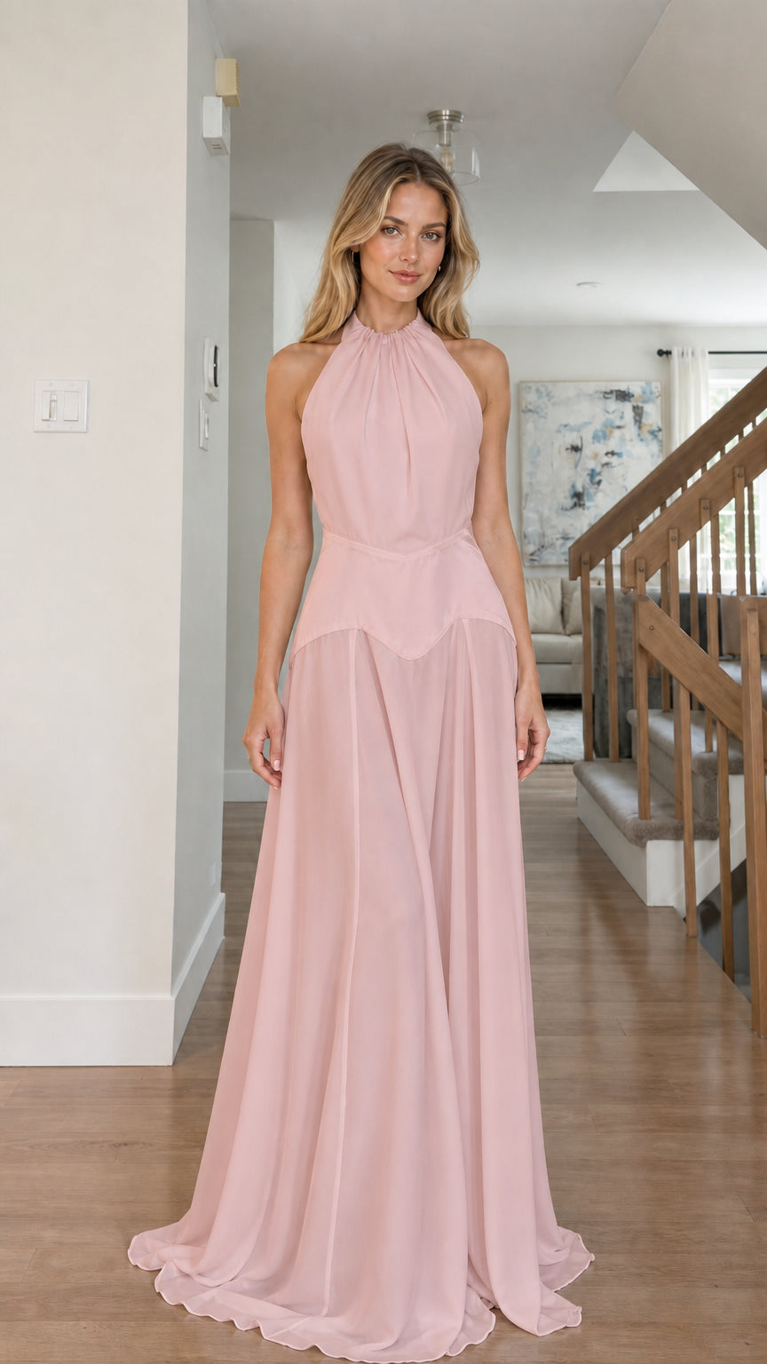 Model wearing blush pink color variant of the halter maxi dress