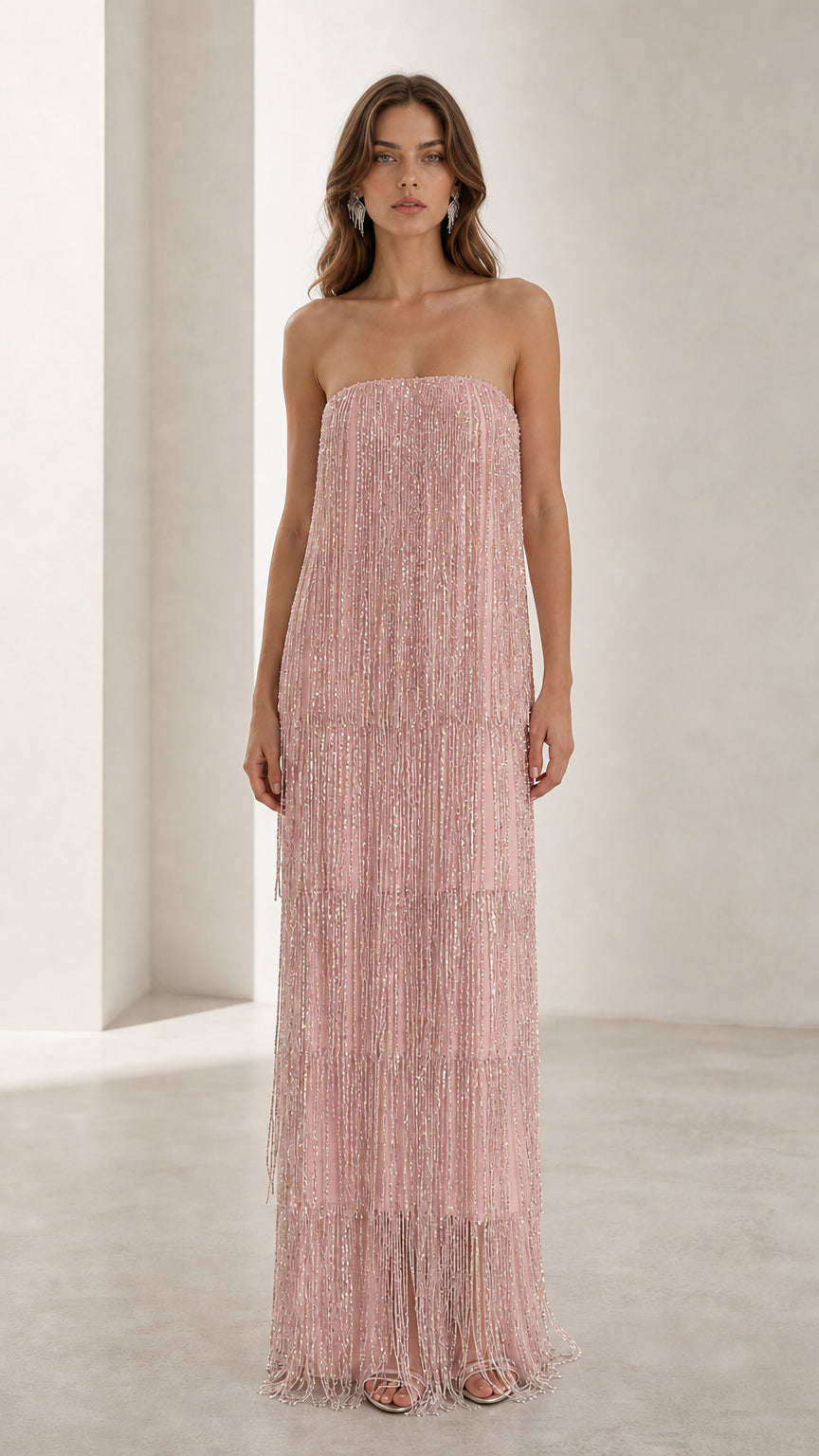 Full view of woman in soft pink strapless beaded fringe maxi dress