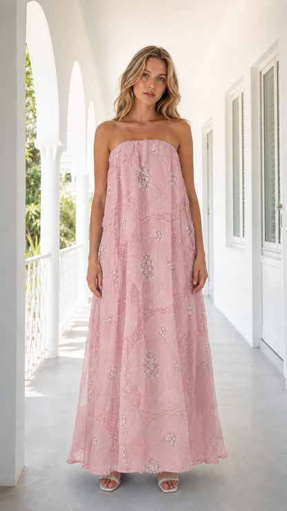 Front view of woman wearing pink strapless embroidered floral maxi dress