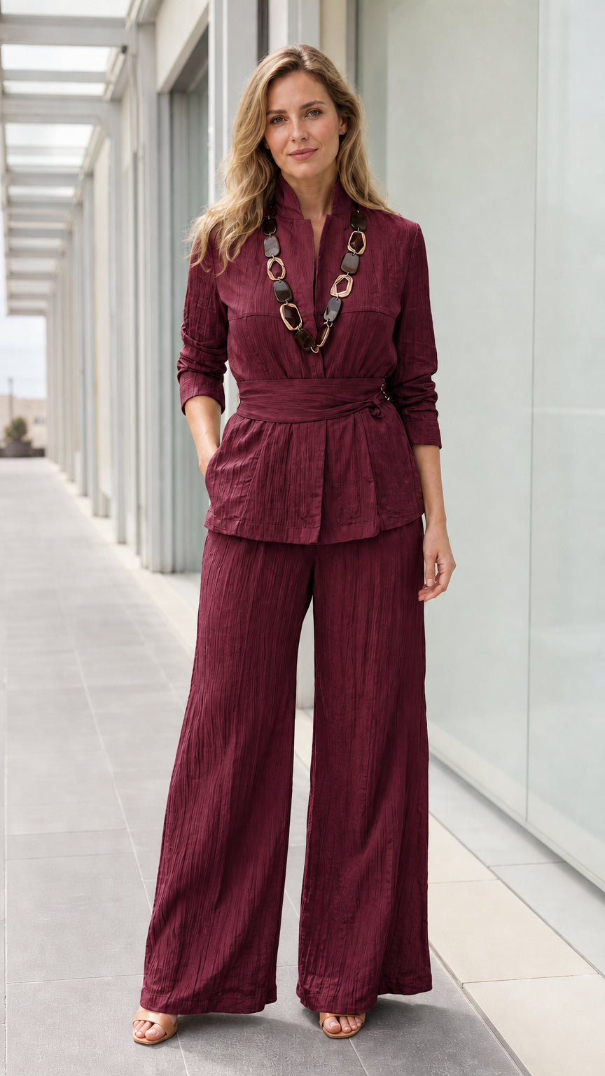 Front view of woman wearing burgundy textured two piece pants set
