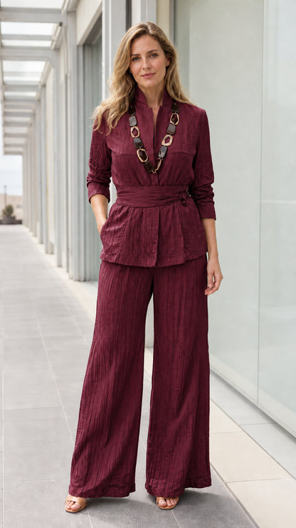 Front view of woman wearing burgundy textured two piece pants set