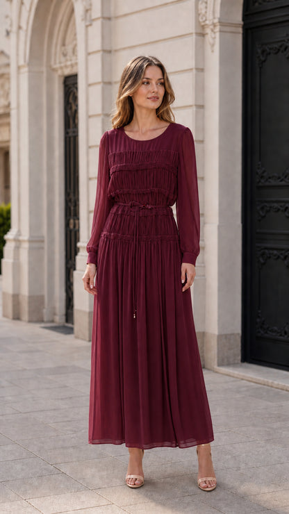 Front view of model wearing burgundy pleated long-sleeve maxi dress