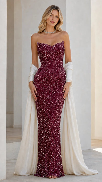 Front view of burgundy beaded strapless evening dress with draped wrap