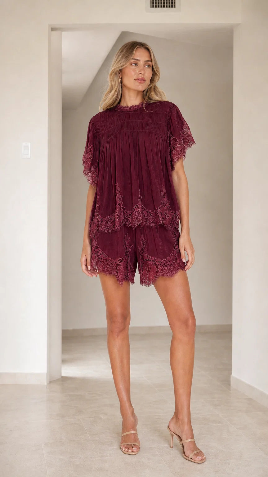 Front view of Burgundy lace trimmed tiered short set on model