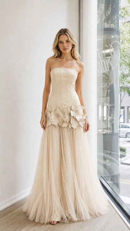 Front view of champagne strapless evening dress with floral appliques