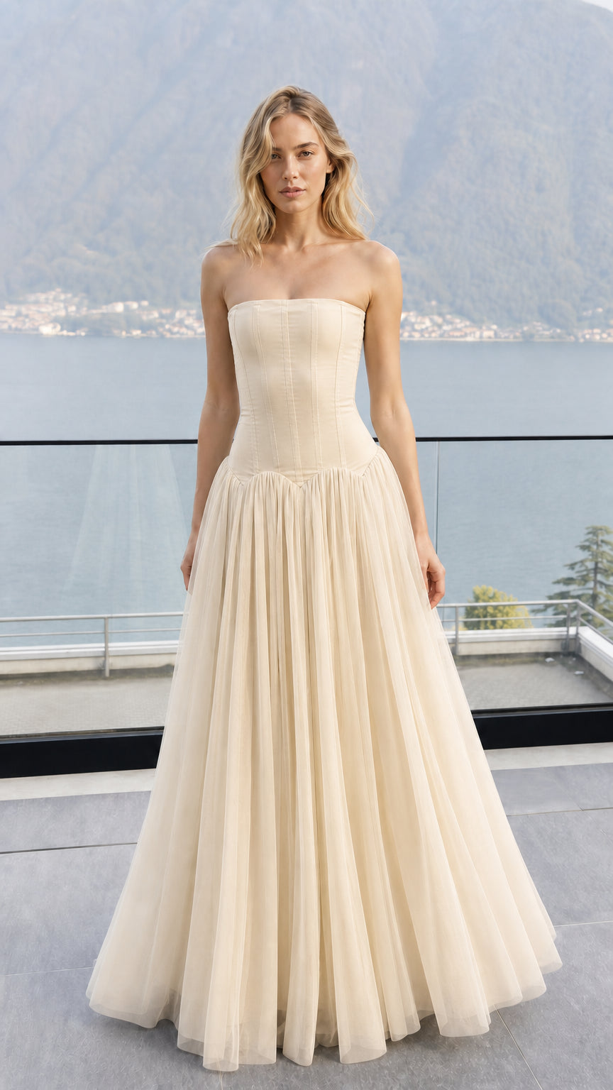Front view of model wearing champagne strapless corset tulle maxi dress