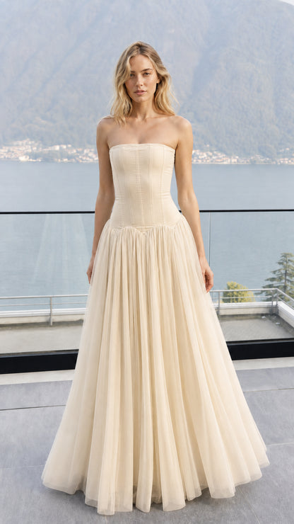 Front view of model wearing champagne strapless corset tulle maxi dress